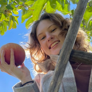 Photo of intern Emily Wallace holding an apple
