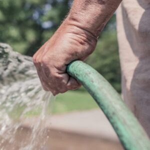 hand holding a hose with water