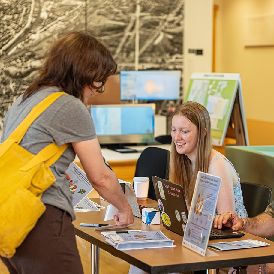 An intern at an event registration table